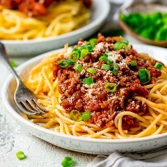 A bowl of pasta with many different types of food on a plate

Description automatically generated